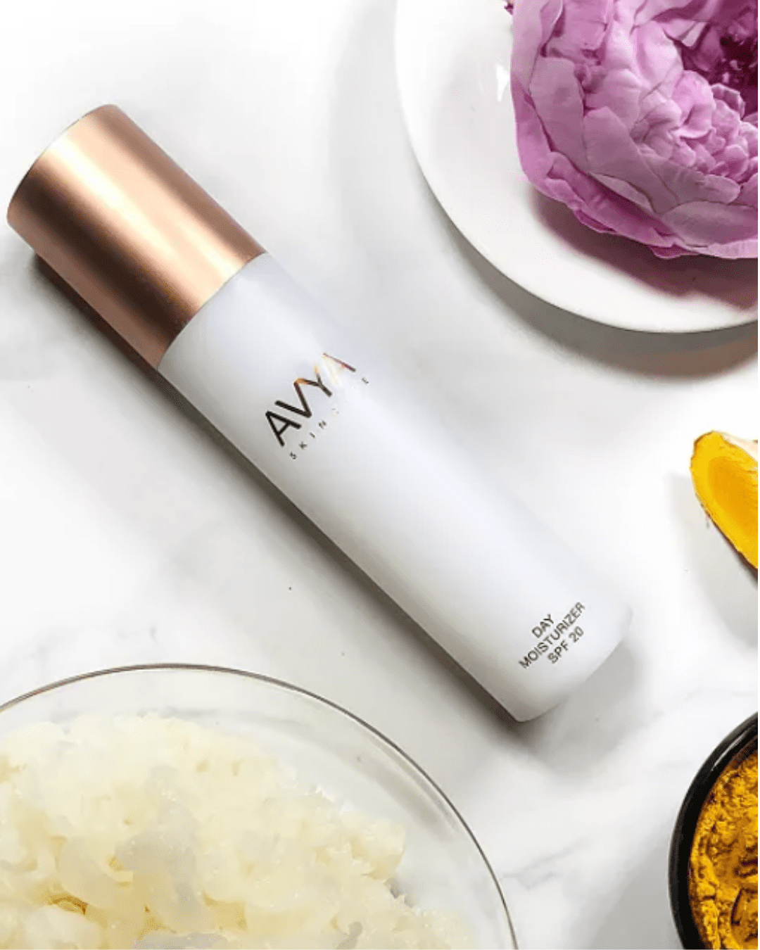 Avya Advanced Ayurveda Skincare Moisturizer with SPF. objects on plates are nearby. A product that is Ayurvedic skincare.
