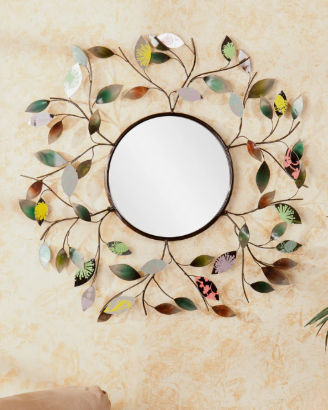 SEI Millara Decorative Metallic Leaf Wall Mirror hung in natural light to invite positivity into your home