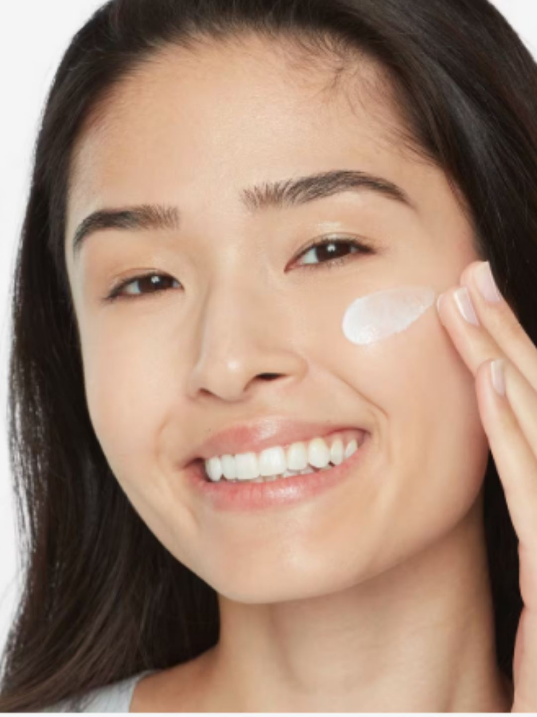 Olay Regenerist Niacinamide + Peptide 24 Hydrating Moisturizer with an Asian woman applying the product to her cheek.