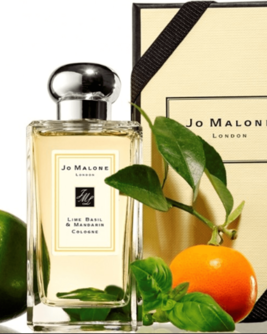 Jo Malone London Lime Basil and Mandarin Cologne next to its packaging and an orange complete with its leaves in this fall self-care guide.