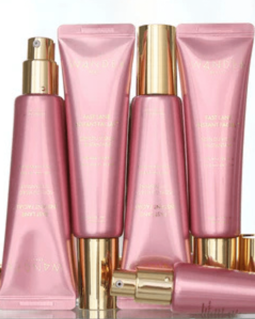 Multiple Wander Beauty’s Fast Lane Instant Facial bottles, upright and upside down on reflective mirrored surface, effective safer alternative to raw egg face masks.