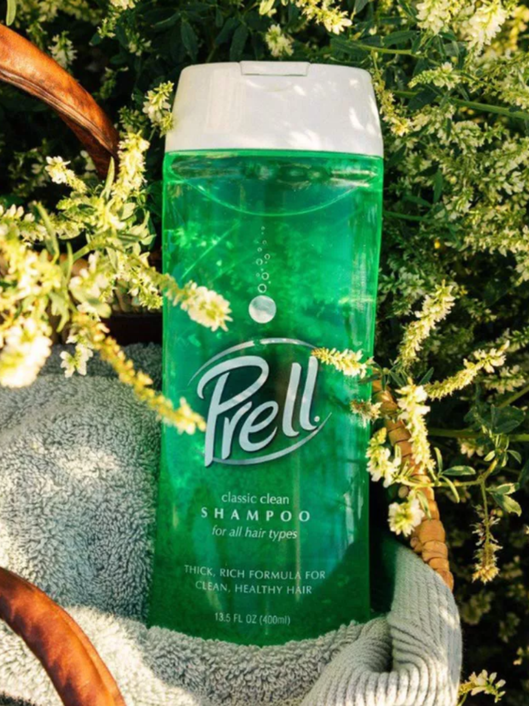 Prell shampoo bottle outside in nature.