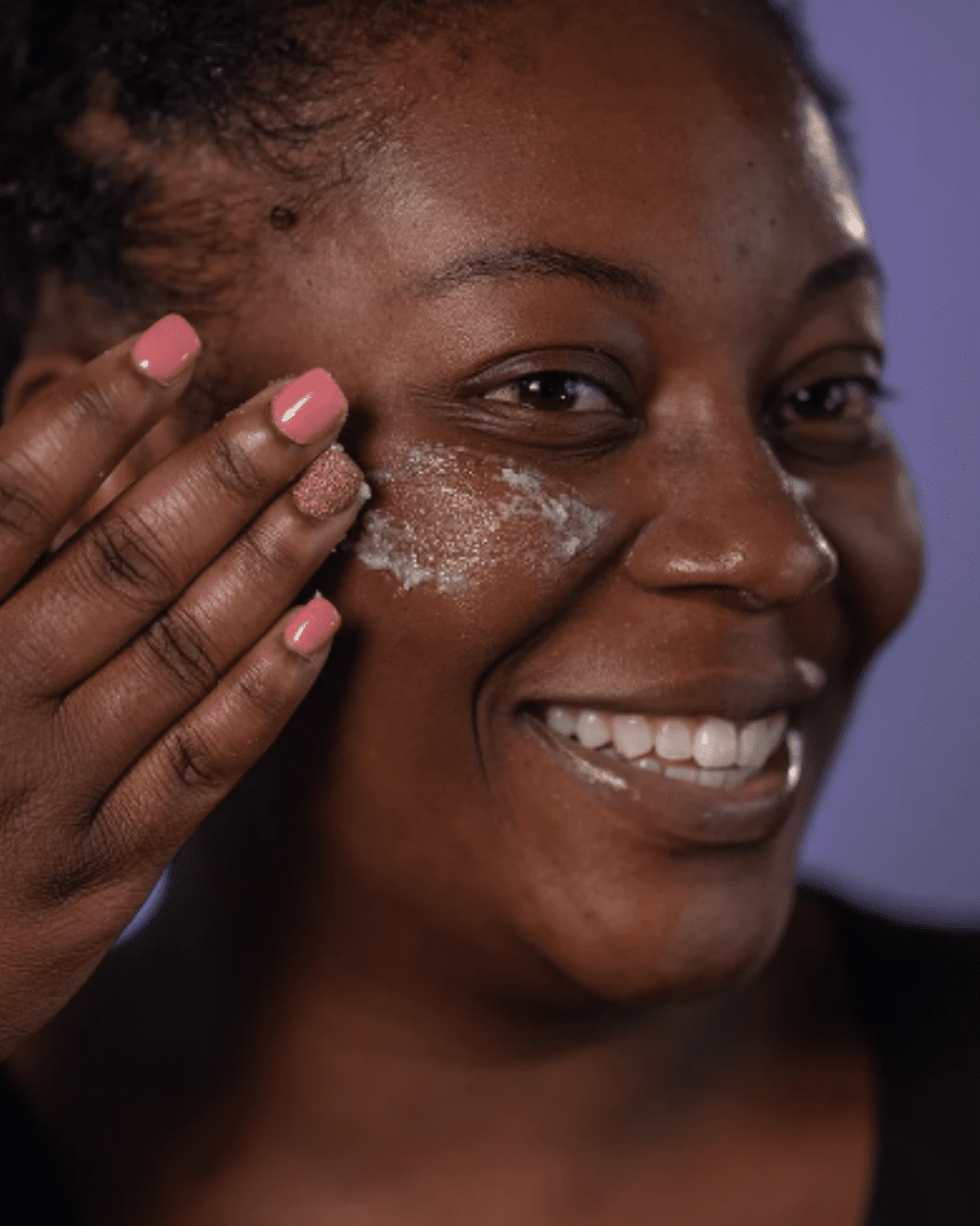Black woman with Hey Honey’s Propolis Scrub on her face