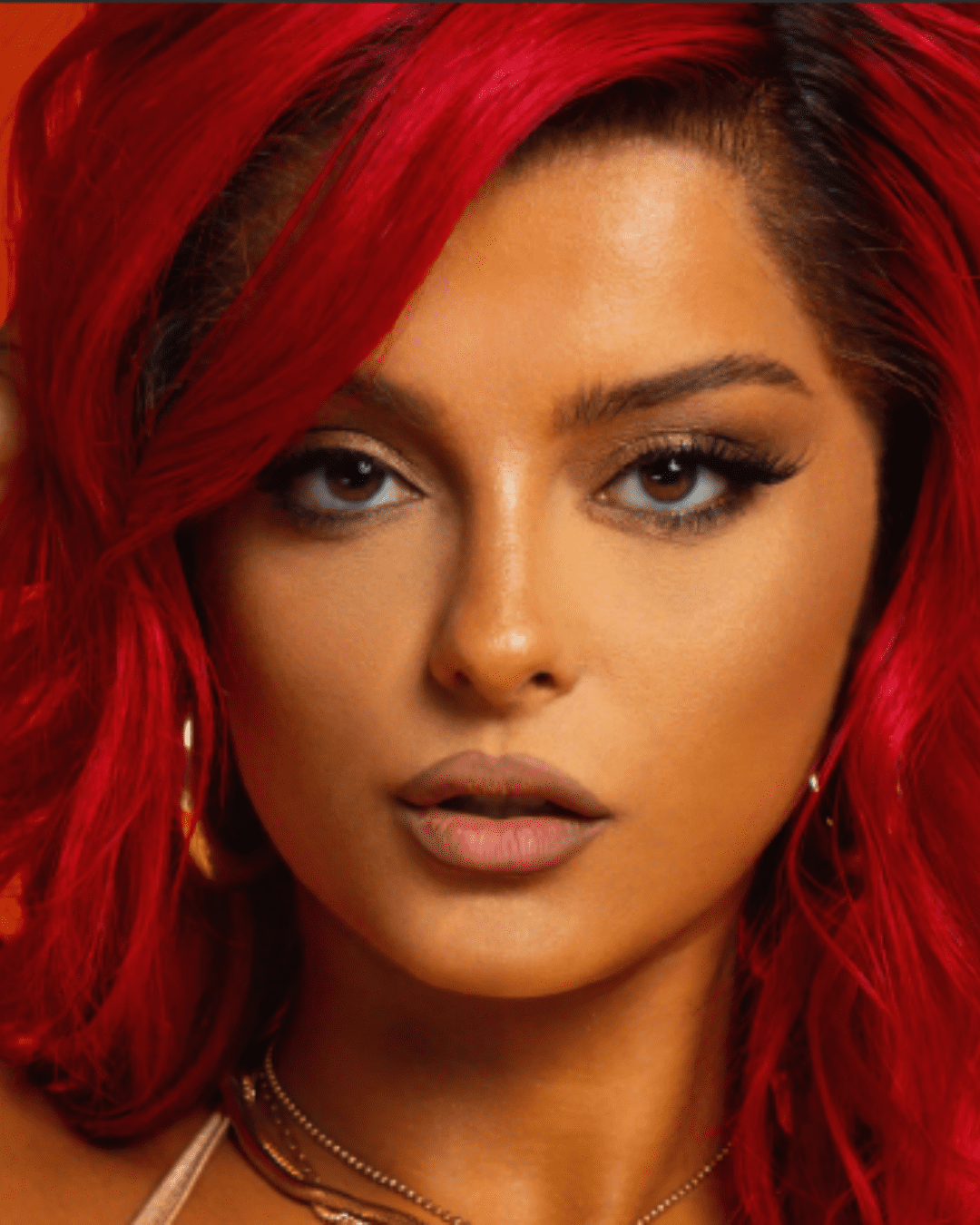 Bebe Rexha with a full face of makeup, covering her real skin.