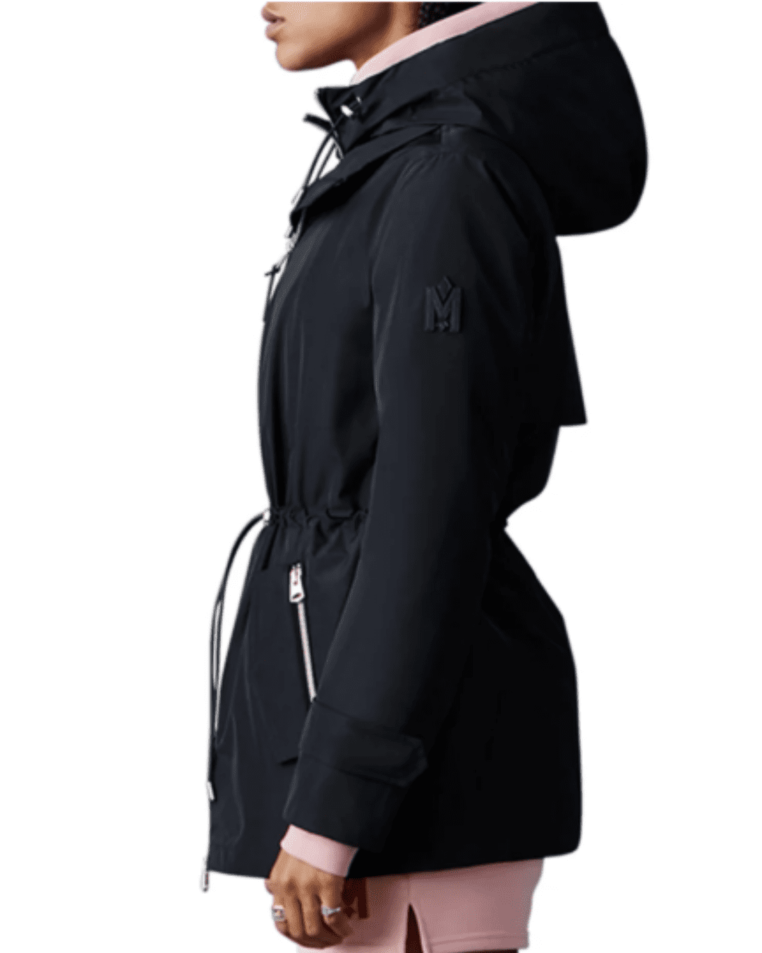 Black woman wearing Mackage Melany Hooded Raincoat, side view, paired with pink shorts, white shoes, and hood up, stylish rain protection.