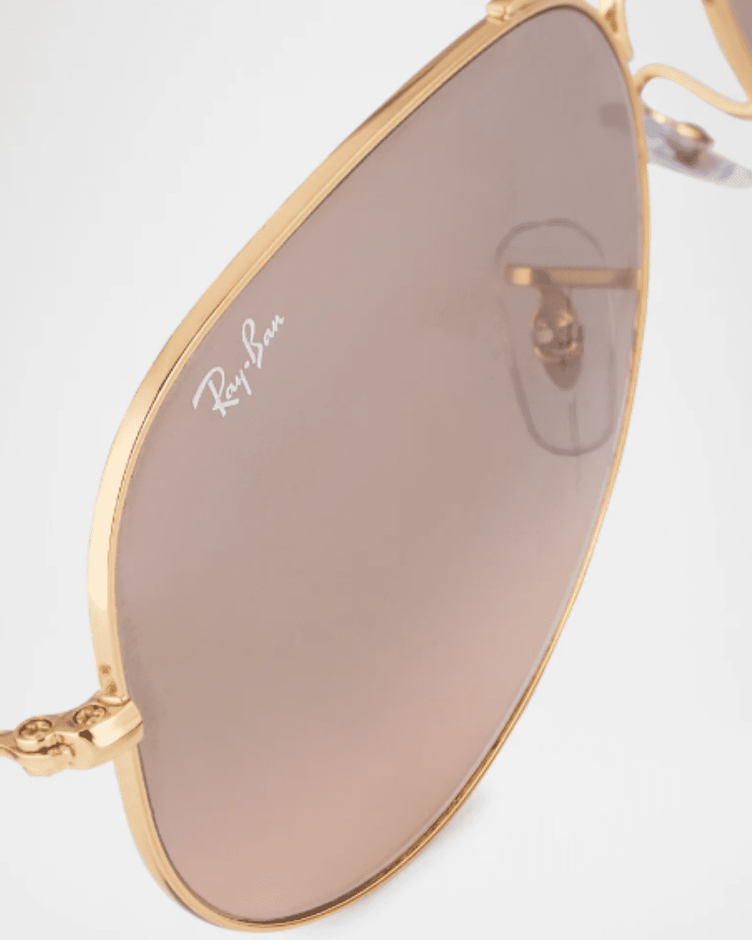 Close-up of Ray-Ban Mirrored Flash Aviator Sunglasses lens showing Ray-Ban logo and reflective UV-protective coating.