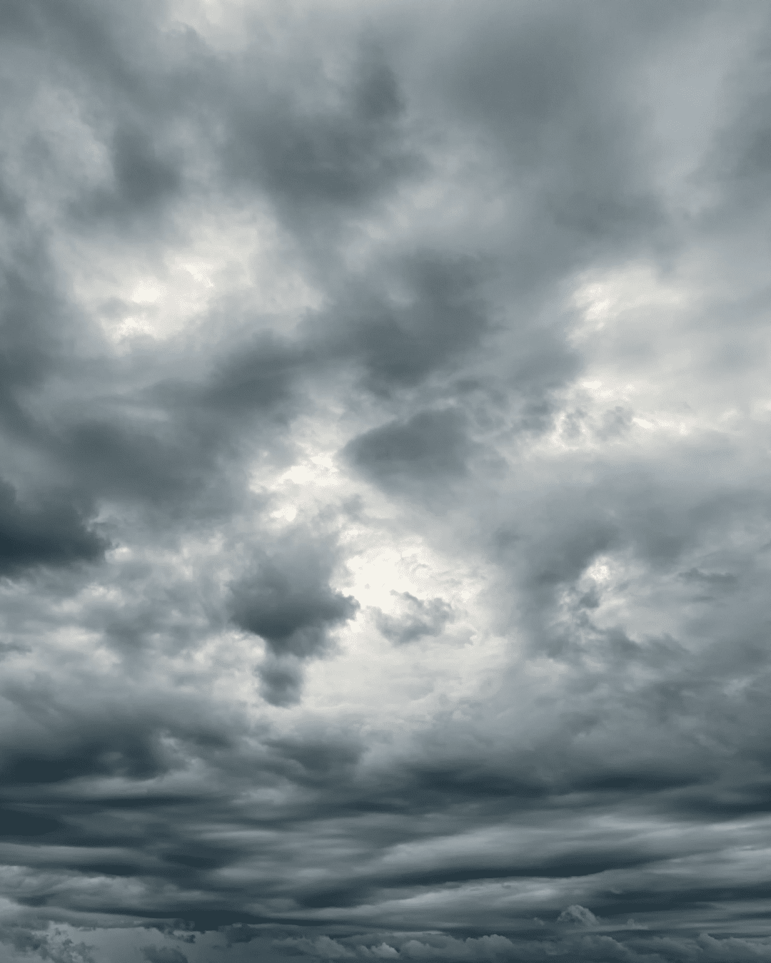 Overcast sky with gray clouds signaling rain, moody weather scene.