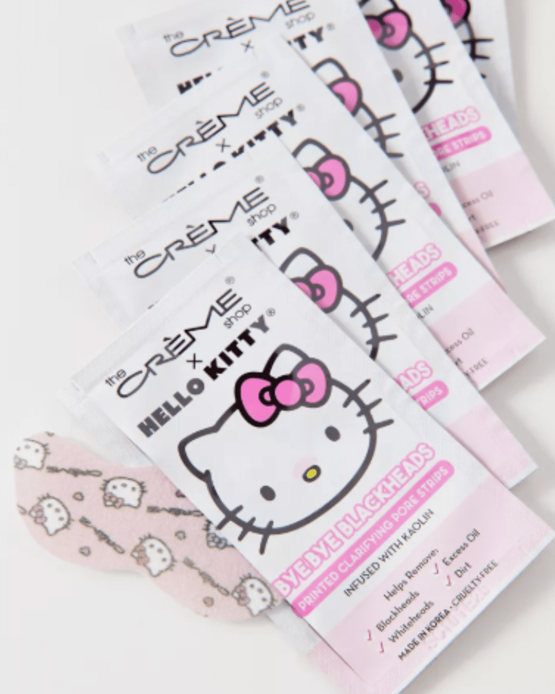 Six nose strip sheets from The Creme Shop Sanrio & Hello Kitty Bye-Bye Blackheads lined up slightly overlapping, with one Hello Kitty nose strip visible in the bottom left corner.
