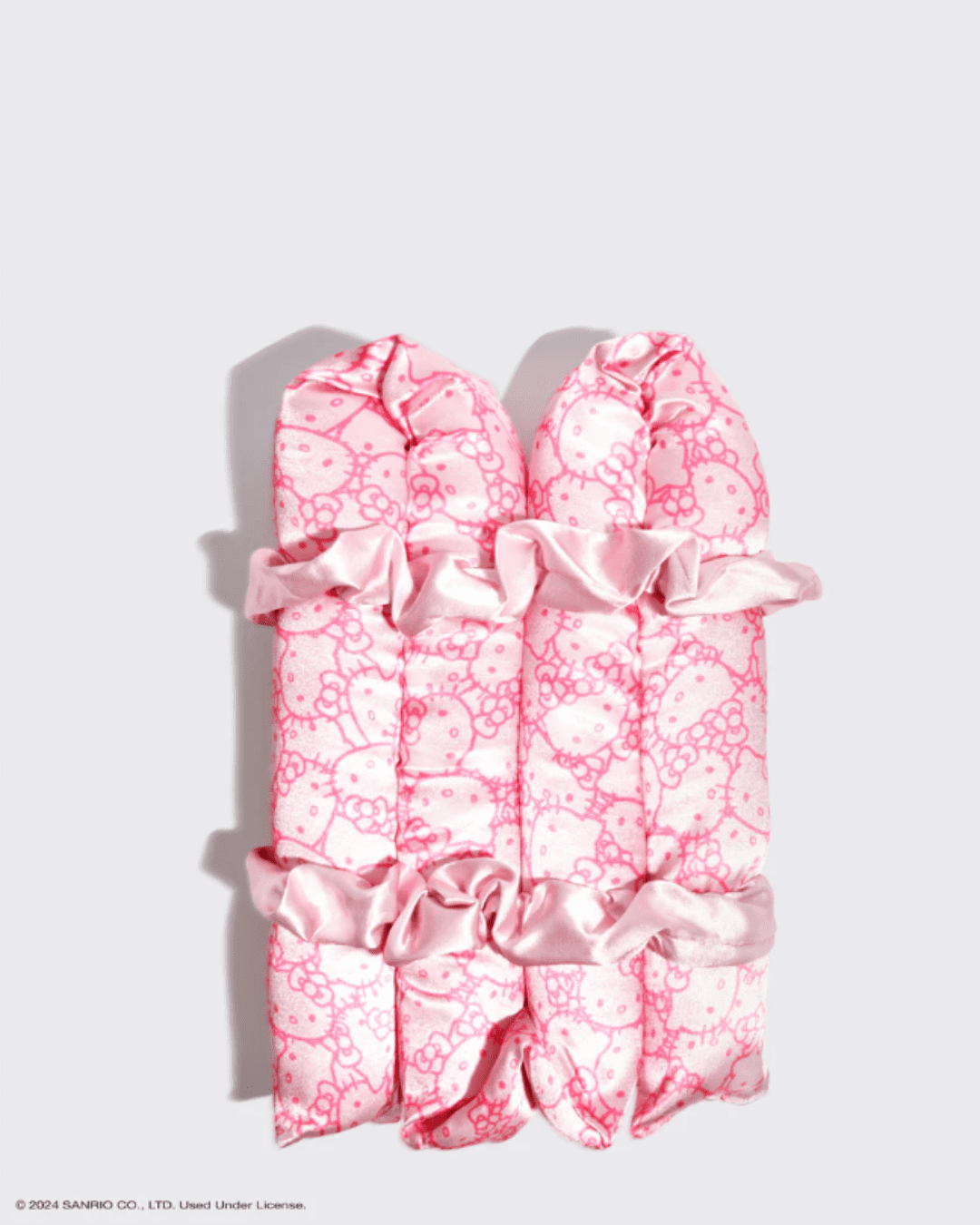 Close-up of the Kitsch Hello Kitty Heatless Curling Wrap with two matching scrunchies, displayed on a gray background.