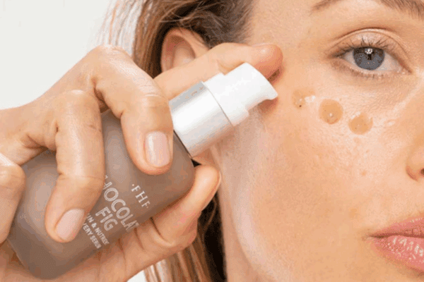 Woman putting serum on her face