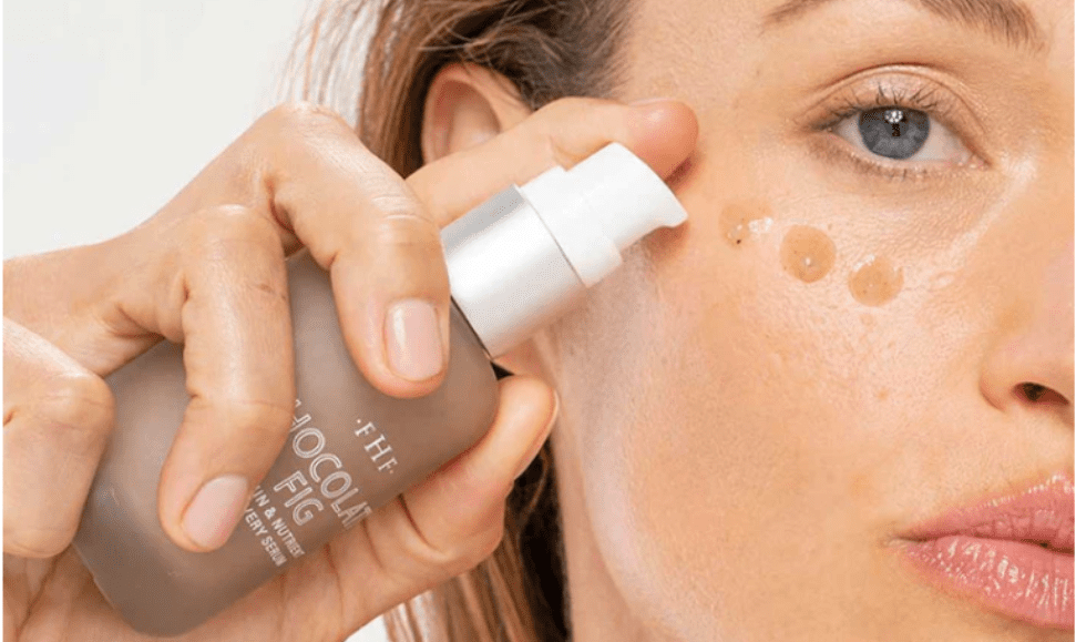 Woman putting serum on her face