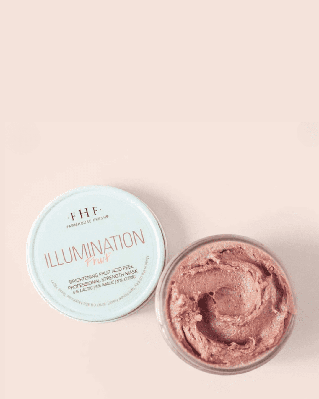 FarmHouse Fresh Illumination Fruit™ Professional Strength Peel jar on a pink-orange surface with lid beside it, highlighting the natural color variations from fruit in the peel.