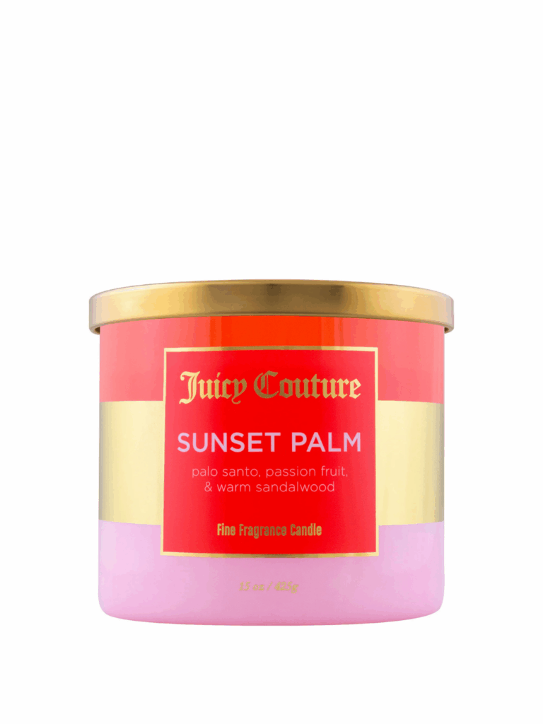 Juicy Couture Sunset Palm Candle on a white background, featuring a sunset-striped jar with red-orange, gold, and pale pink bands and a gold lid, labeled with notes of Palo Santo, passionfruit, and warm sandalwood.
