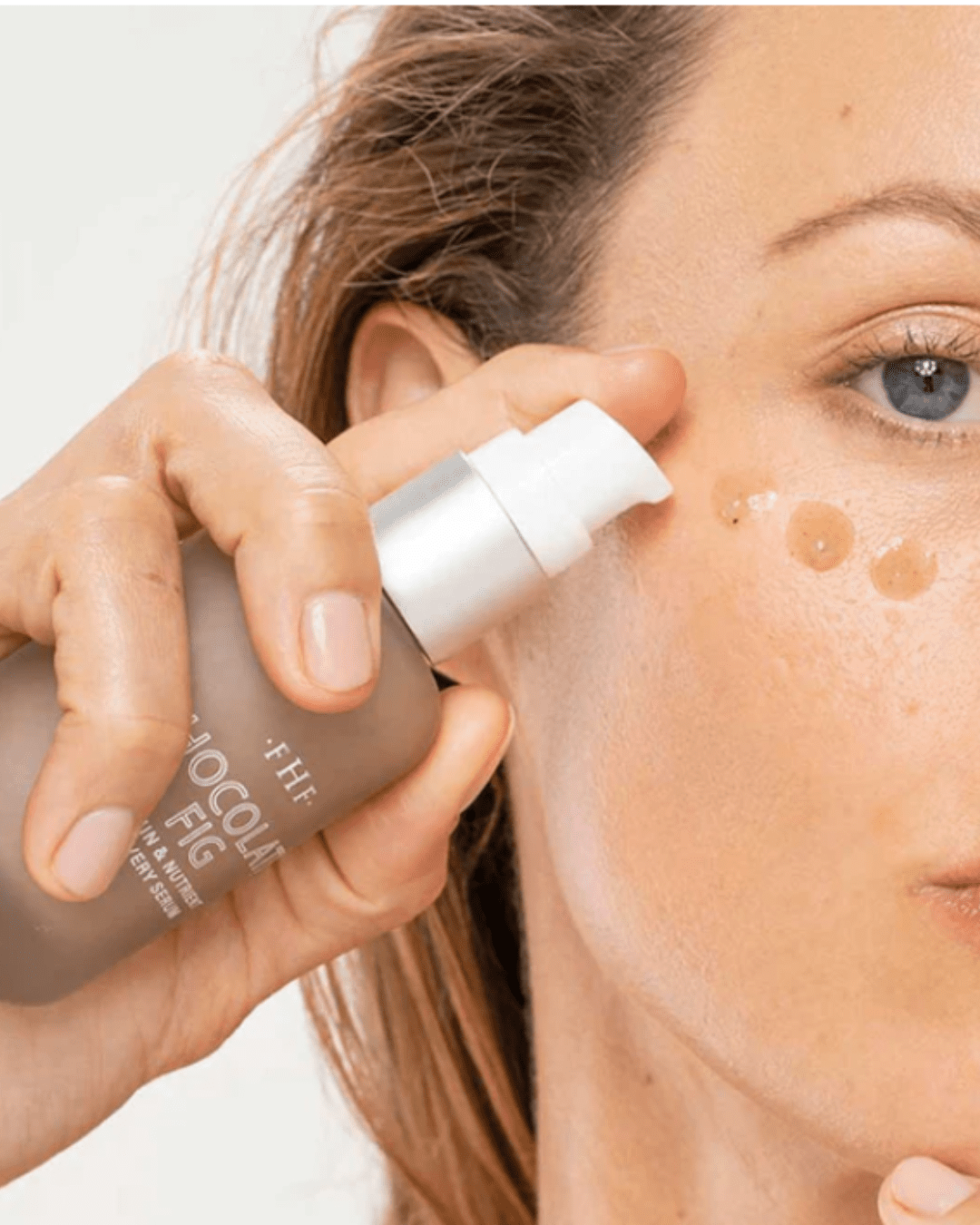 woman putting Farmhouse Fresh Fig Vitamin Recovery Serum