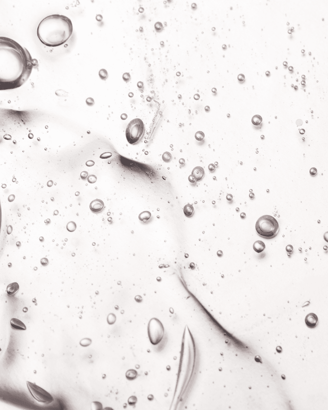 Clear gel texture with air bubbles representing hyaluronic acid skincare ingredient.