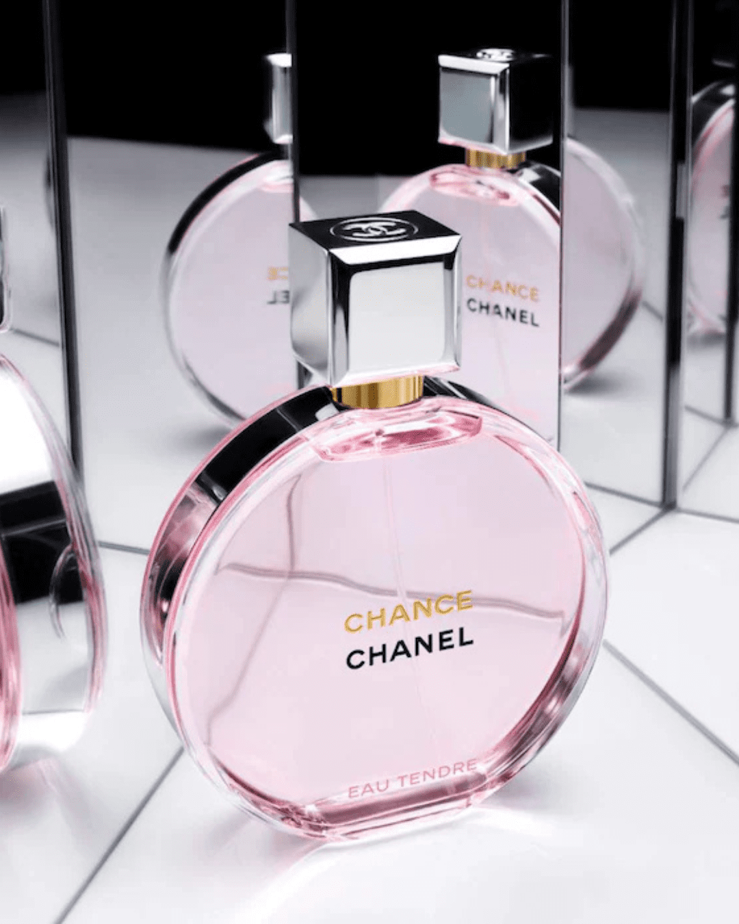 Chanel Chance Eau Tendre perfume bottle with angled mirrors in the background reflecting the bottle multiple times, a delicate fragrance perfect for layering with ice cream perfumes.