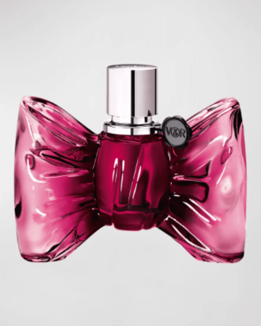 BONBON Eau de Parfum by Viktor & Rolf, pink bow-shaped bottle on a light gray background, showcasing this playful candy perfume.