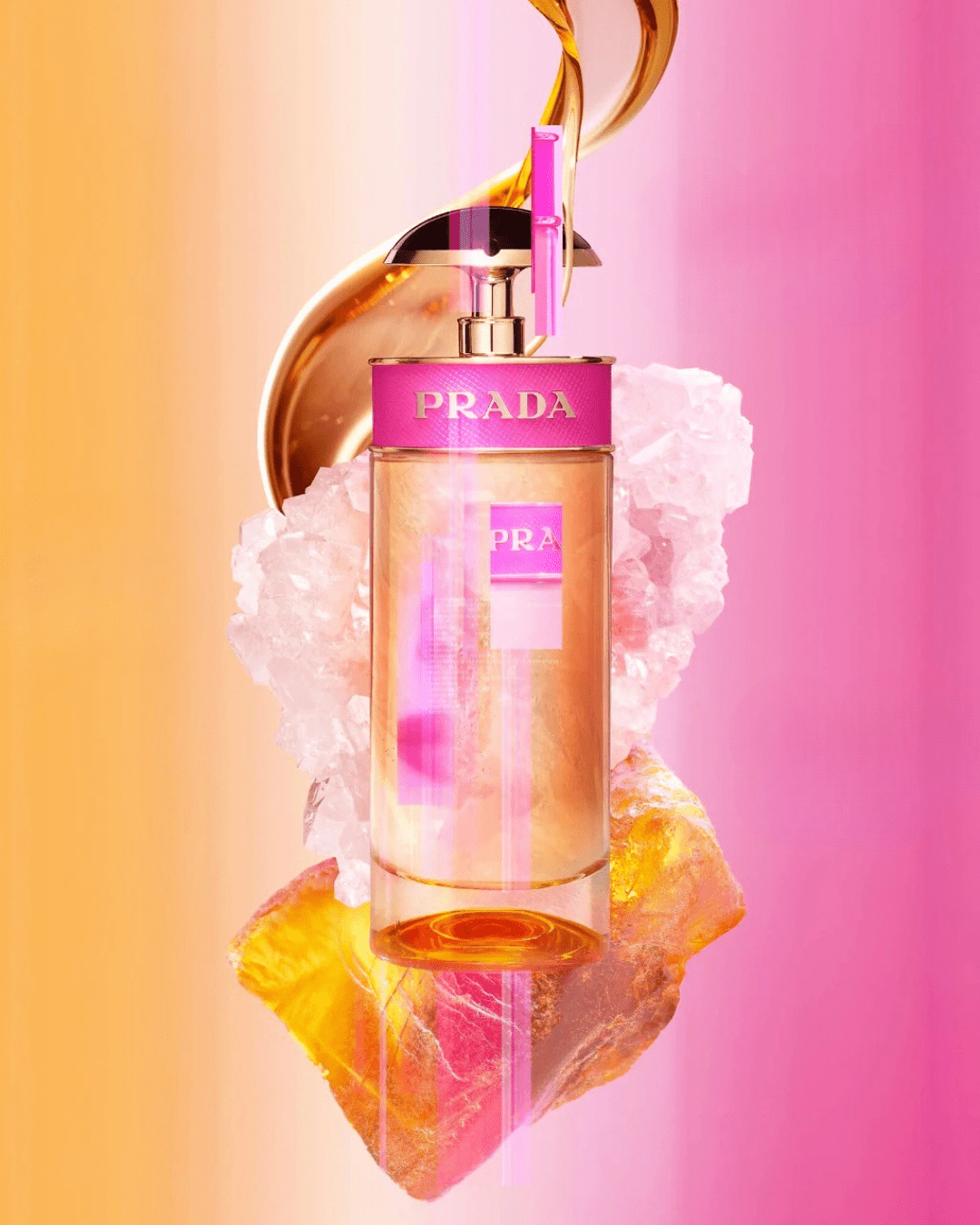 Candy Eau de Parfum by Prada perfume bottle in front of orange-to-pink gradient, with honey swirl, pink flowers, and caramelized notes representing warm, gourmand fragrance.