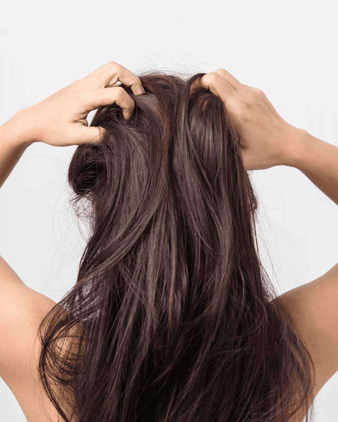 Brown-skinned woman gently massaging Carpe Scalp Serum for Oil and Sweat Control Serum into her scalp, demonstrating application technique.