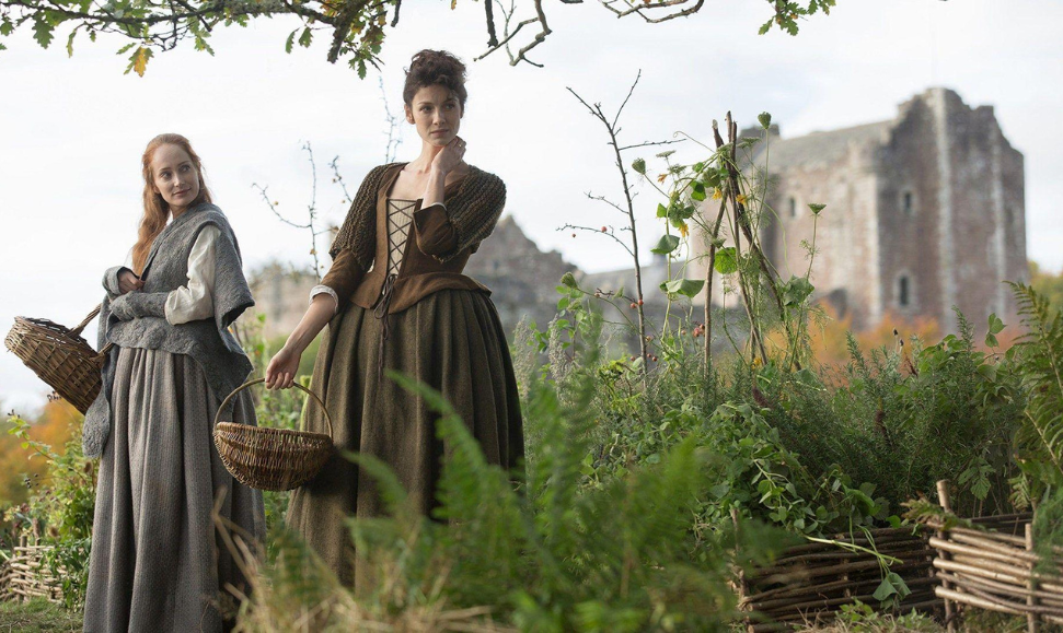 Geillis Duncane and Claire from Outlander discussing herbs, featured image for the Scotland Tartan Memorial blog post.