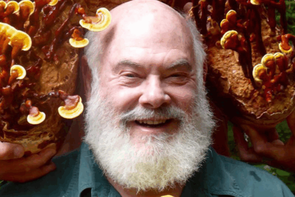 Dr. Andrew Weil surrounded by mushrooms