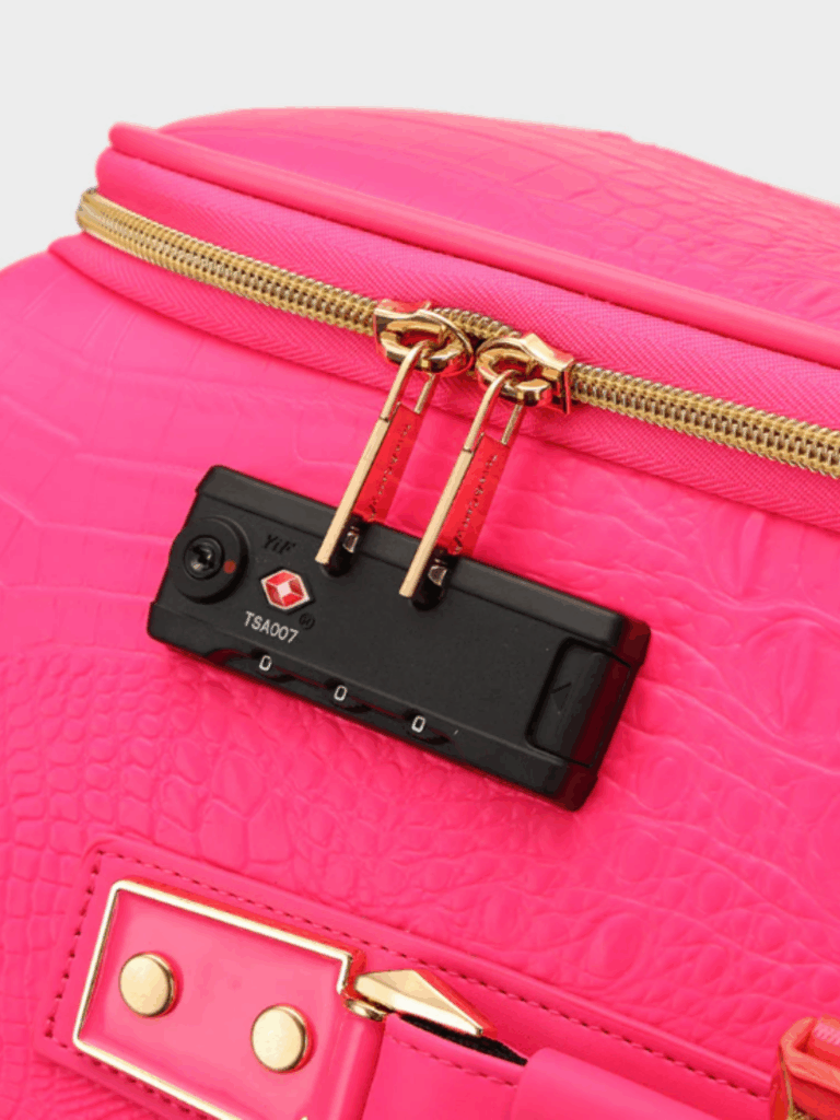 Close-up of the Tote N Carry Statement Carry-On Kit in neon pink vegan leather, showing the gold hardware, dual zippers close together, and part of the handle. The textured material and secure top design make it ideal for stylish travel with space for small essentials like a hand sanitizer.