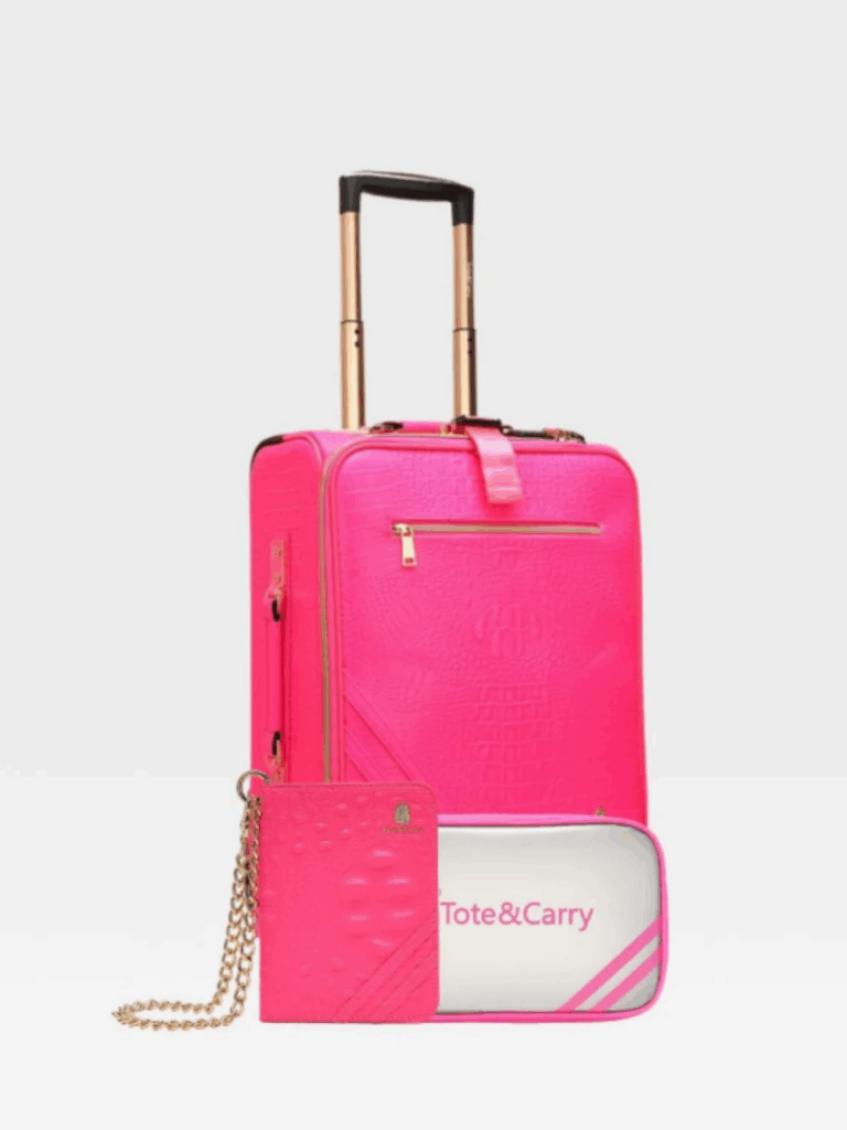 Full view of the neon pink Tote N Carry Statement Carry-On Kit with handle extended on a white background. The luggage features gold hardware, a matching pink wallet or passport holder with chain, and the gold Tote N Carry logo-perfect for travel essentials and a hand sanitizer.