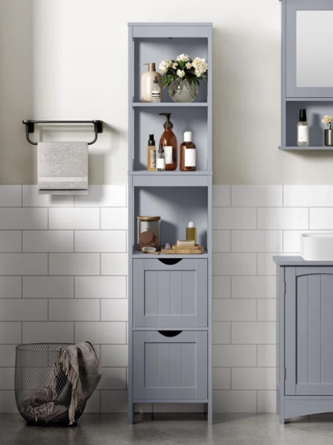 A gray bathroom organizer with drawers and shelves.