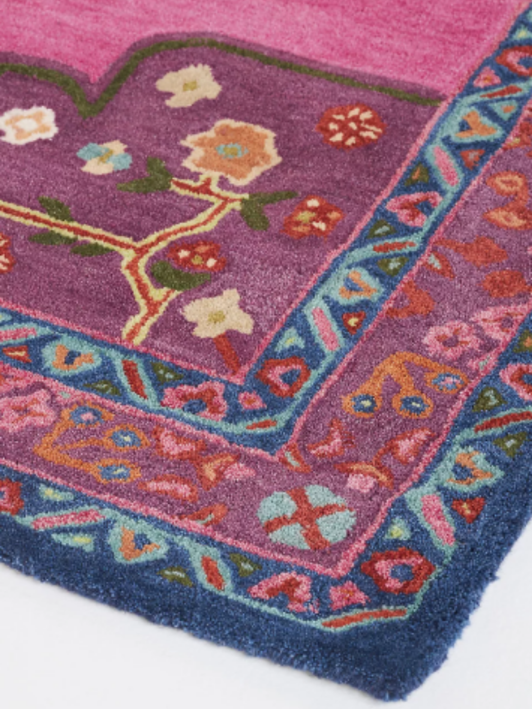 Close-up detail of a pink Bengal tiger hand-tufted wool rug showing the texture, pile depth, and intricate tiger design for a tactile, editorial home decor look.