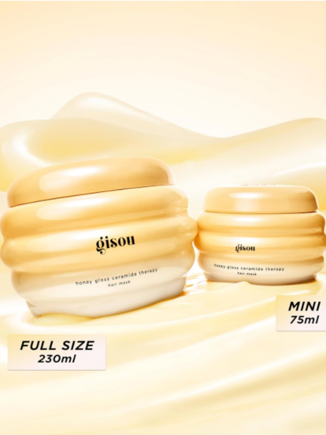 Gisou Honey Gloss Ceramide Therapy Hair Mask on a mask textured background showing the regular and small size of the product packaging.