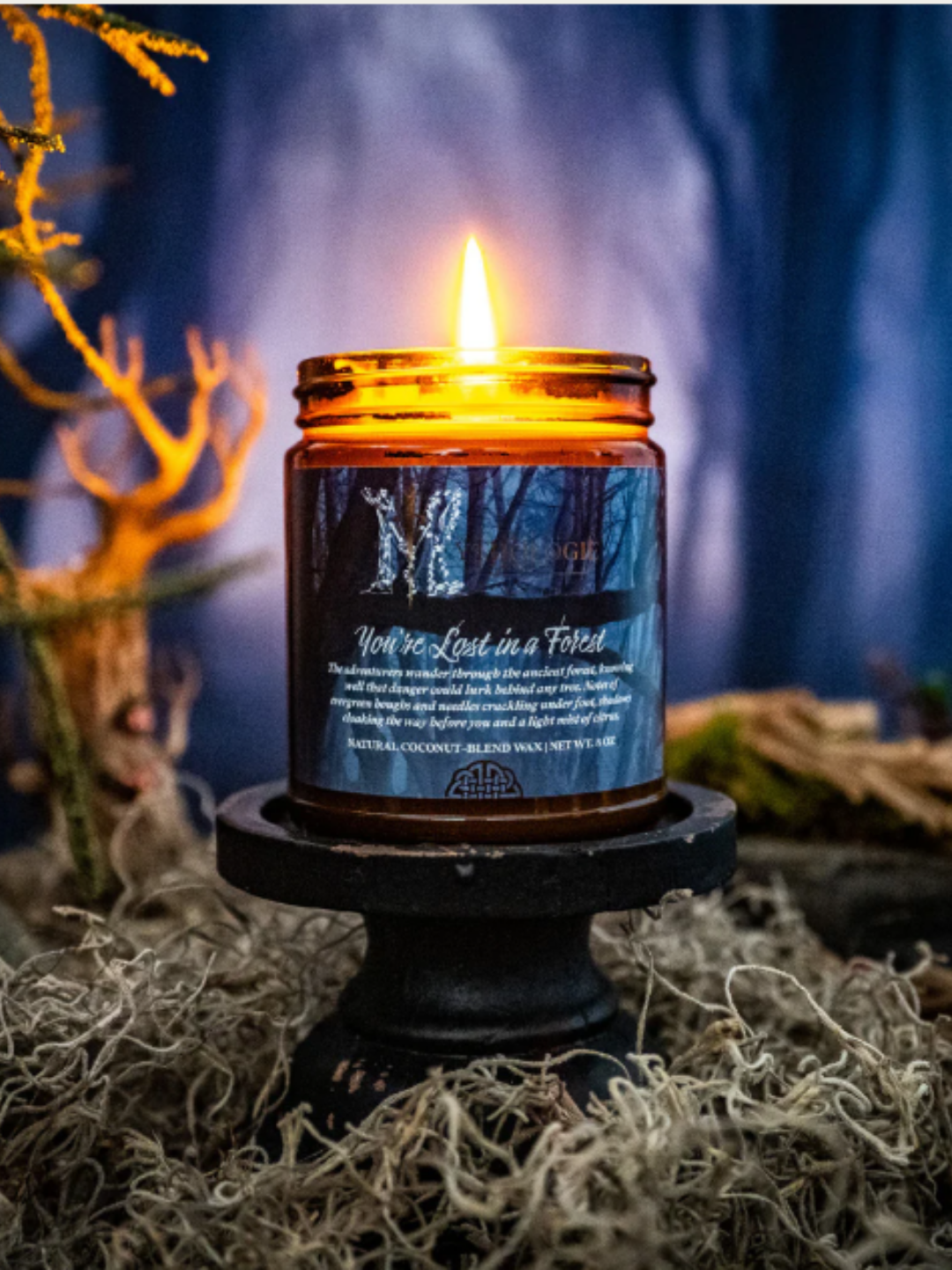 You’re Lost in a Forest by Mythologie Candles with deep blue forest background, evoking the mythical woods of Middle-Earth in the Glamlite Lord of the Rings collection.
