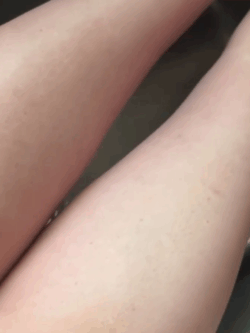 Side-by-side view of my legs in natural lighting showing before-and-after results from using the Ancient Owl Naturals Golden Hour Glow Body Oil- the left leg glistens with a golden shimmer while the right leg remains bare, highlighting a radiant self-love glow.