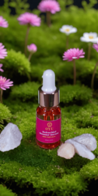 OYU Botanica Bakuchiol Booster Serum bottle displayed among crystals, with small pink flowers rising from the surface in the background, creating a natural, serene skincare scene.